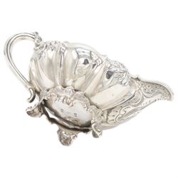 William IV silver twin handled sucrier and milk jug, each of circular bellied form, embossed with floral decoration, upon four pad scroll feet, hallmarked London 1831, maker's marks CE, including handles H10cm