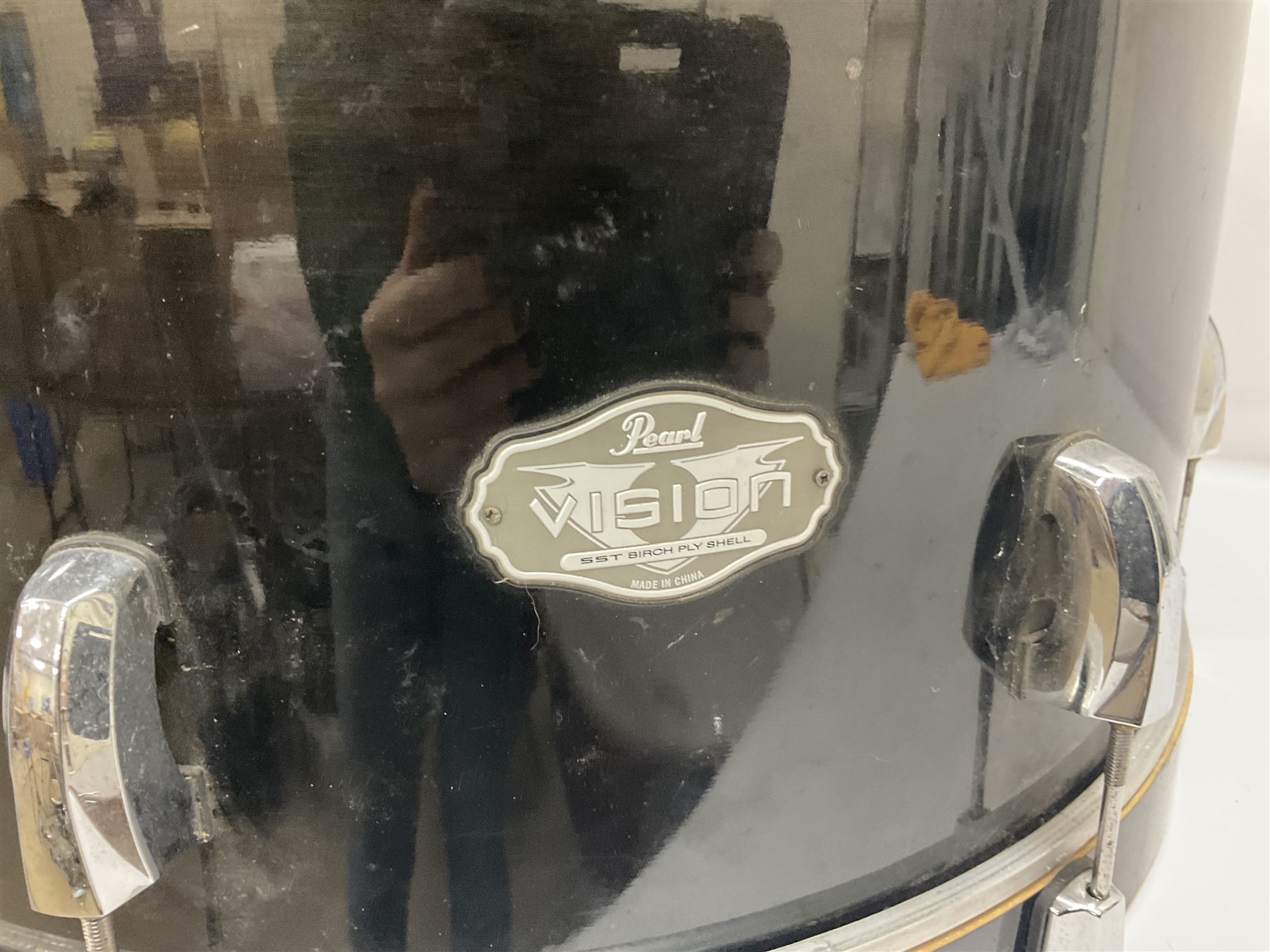 Pearl Vision SST Birch Ply shell four-piece drum kit in black comprising bass drum with foot pedal and three graduated toms; together with Pearl Custom Alloy Sensitone steel snare drum, drum and cymbal stands, microphone stand, stool and various drum sticks 