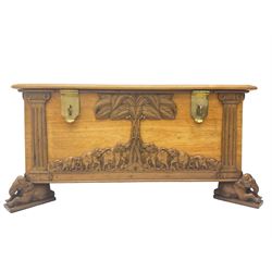 India camphor wood blanket box, moulded hinged lid, decorated with carved elephants and trees, on elephant carved feet