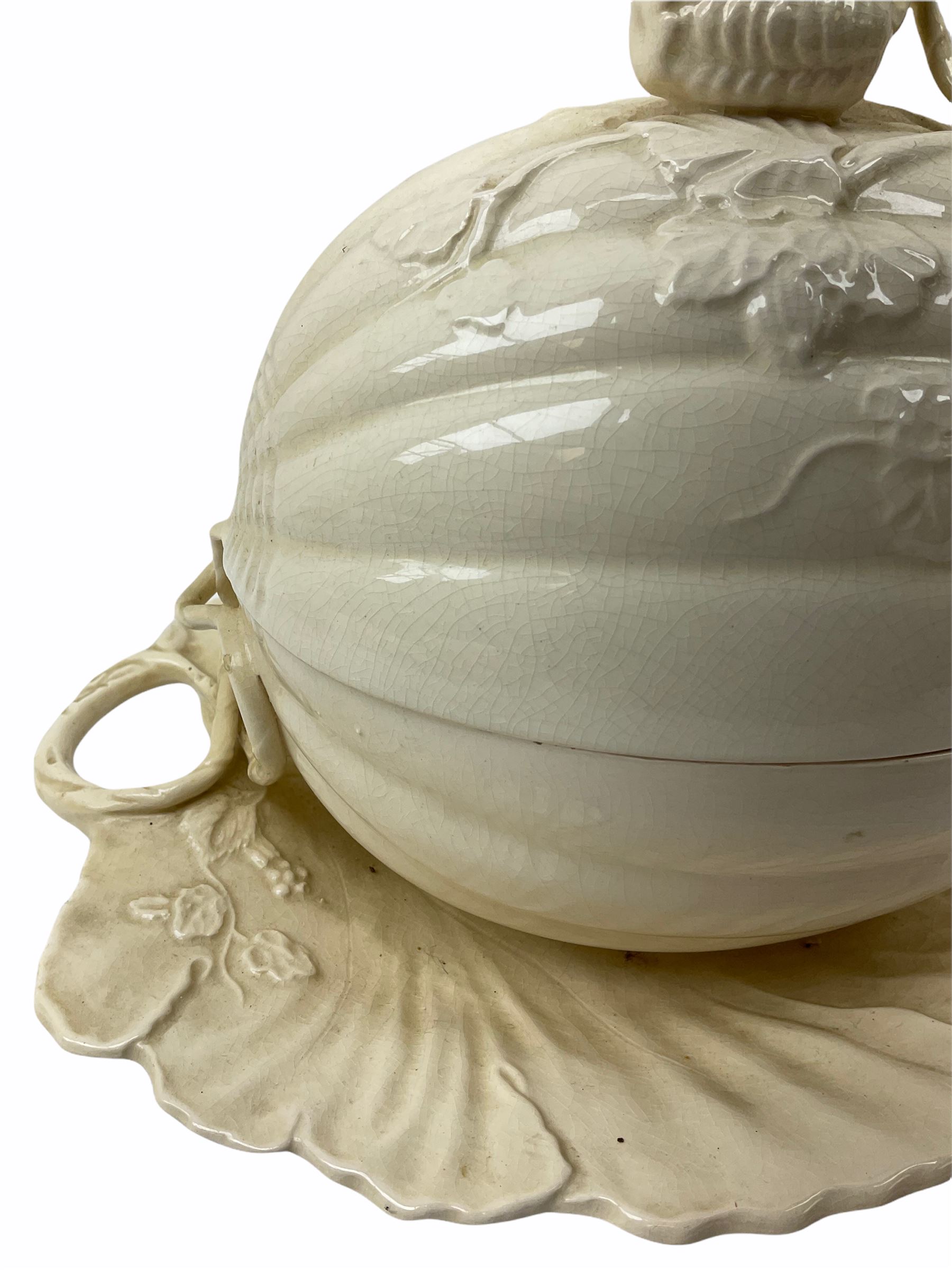 20th century Leeds creamware, comprising chestnut basket and stand, small tureen and cover, ladle, and associated stand, candlestick with stem modelled as a dolphin, teapot, tureen and cover in the form of a melon with fixed stand, and toast rack (toast rack a/f), each with impressed mark beneath. 