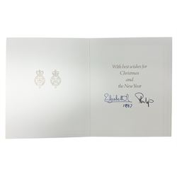 H.M. Queen Elizabeth II and HRH the Duke of Edinburgh - 1987 Christmas card with printed photographic front of a Royal Family group, the inside with two cyphers and signed Elizabeth R and Philip with manuscript date 1987 below