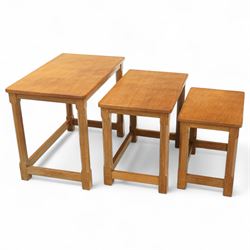 Mouseman - nest of three oak occasional tables, rectangular adzed top, on octagonal supports united by plain stretchers, each carved with mouse signature, by the workshop of Robert Thompson, Kilburn