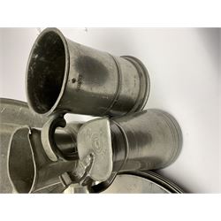Collection of 18th and 19th century pewter, comprising two chargers, eight large plates, twenty six smaller plates, two bowls, three lidded measures, two jugs, tappit hen, and tankard, the plates with various marks and touch marks, including pseudo 'hallmarks', largest charger 37cm, large plates D30cm, smaller plates D24.5cm, tappit hen H26.5cm