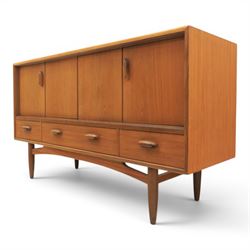 G-Plan - 'Brasilia' teak sideboard, with rectangular top above two concertina doors, above four drawers raised on cylindrical supports
