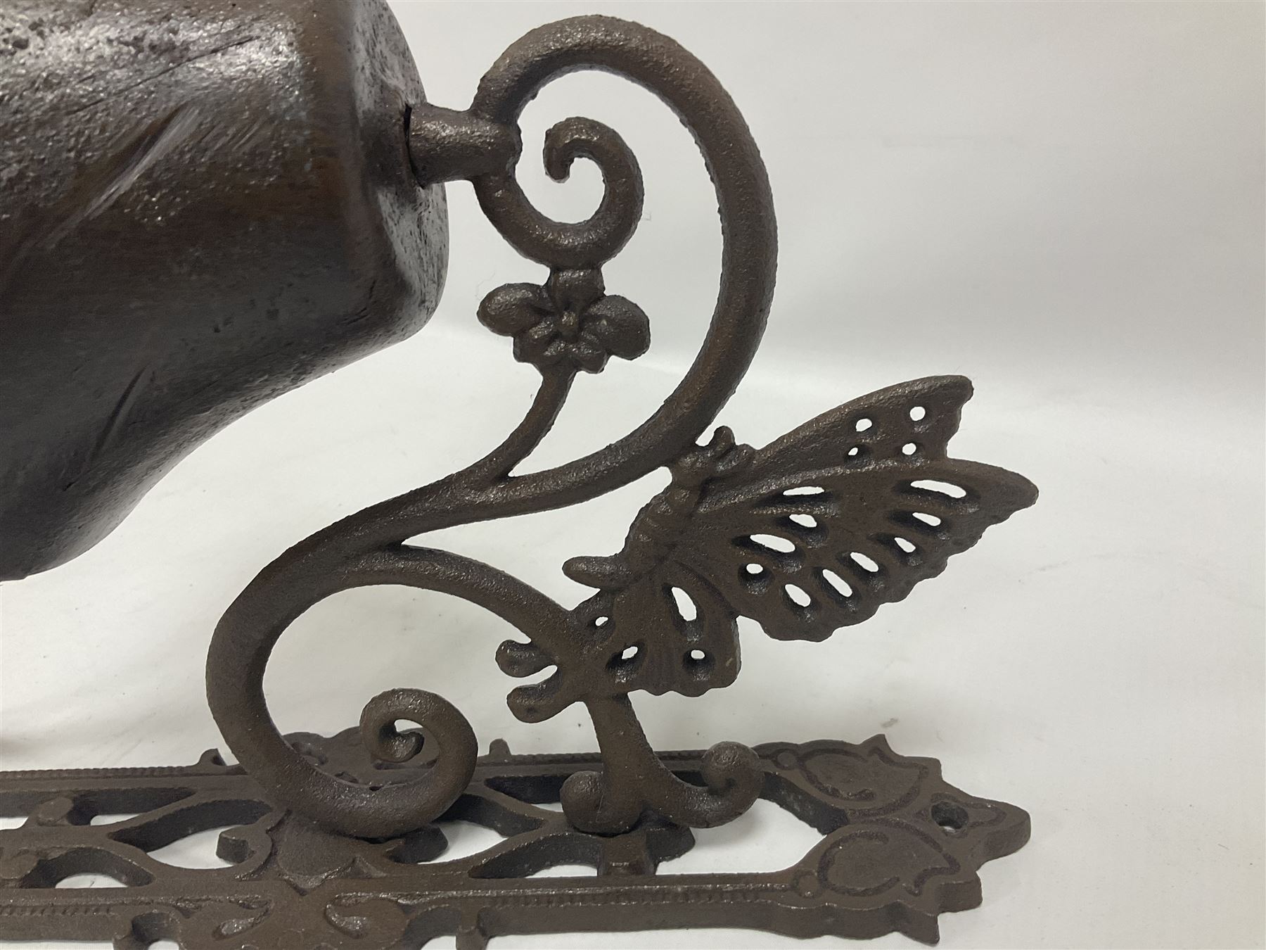 Cast iron exterior hanging garden bell with decorative butterfly bracket