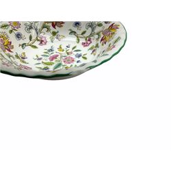 Minton Haddon Hall pattern tea and dinner wares, including basket dish, two covered tureens, six dinner plates, eight dessert plates, twelve tea plates, six soup bowls, six cereal bowls, teapot, coffee pot, milk jug, covered sucrier twelve tea cups and saucers, six mugs, footed bon bon dish, pair of candlestick holders, cake knife and slice etc (81)