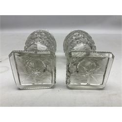 Pair of early 19th century heavy cut glass vases, the bodies of urn form with hobnail and strawberry decoration and flared petal shaped rim raised upon stepped canted square bases with cut eight-point stars, H17.5cm