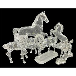  Five Swarovski Crystal horses, comprising stallion, rearing horse, pair of horses playing and Arabian stallion, each with frosted manes and tails, together with a small Swarovski Crystal galloping horse, the mane, tail and base with smoky tint