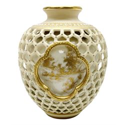 Late 19th century Royal Worcester reticulated double walled vase by George Owen, of ovoid form the openwork outer wall with honeycomb piercing around three quatrefoil panels framing gilt pained landscapes to the inner wall, with puce printed mark beneath, H8.5cm