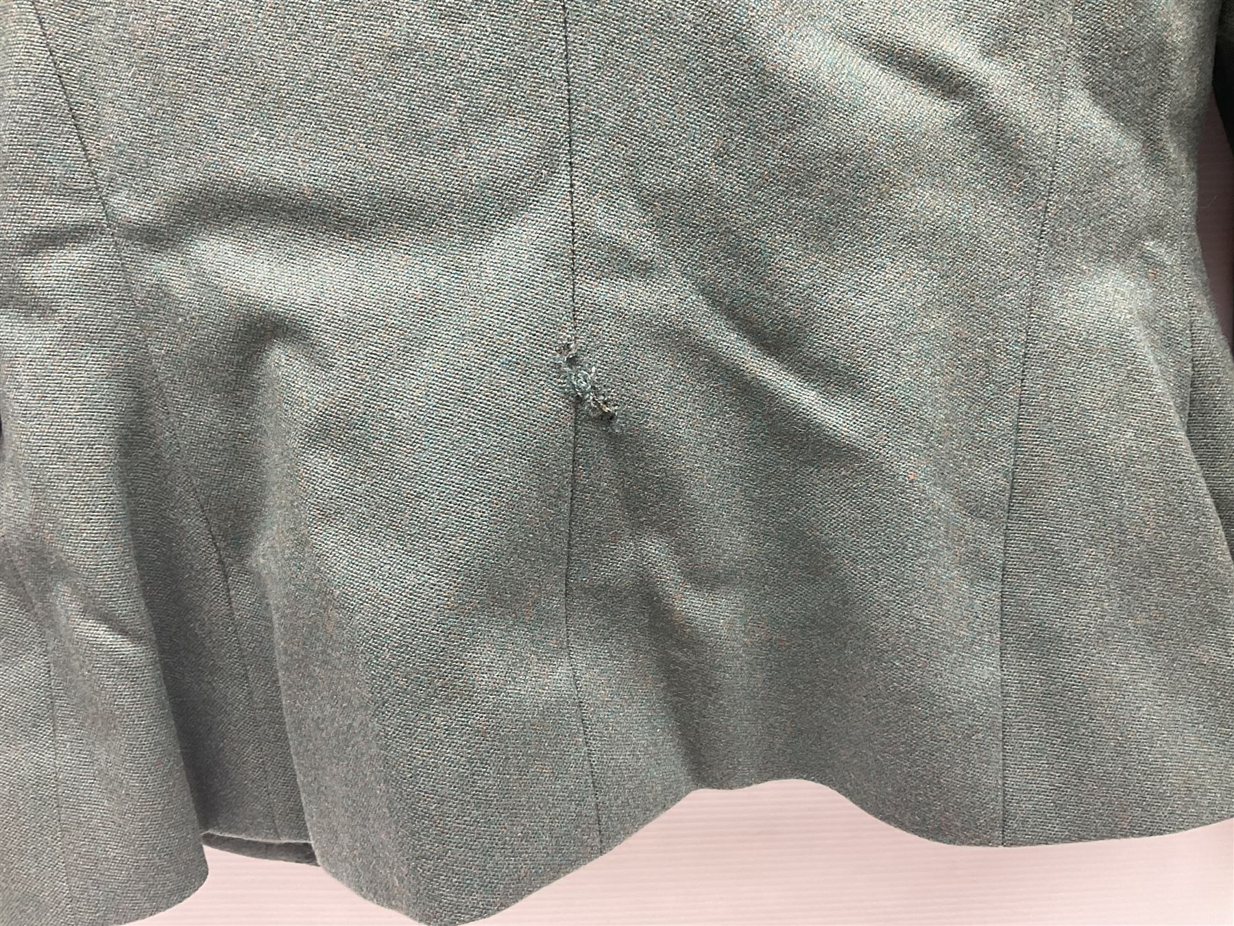 WW2 British female ATS Sergeant's service uniform grouping, consisting of four pocket female pattern service dress tunic with brass ATS shoulder titles and general service buttons; cloth lined interior with the original printed size label dated 1942; the matching khaki service dress skirt; and Greatcoat with size label dated 1945; together with army knitted sleeveless V-neck jumper; WRAC tunic, skirt and overcoat; full length cream and gold thread military evening dress by Hilliers Couture; and four webbing belts