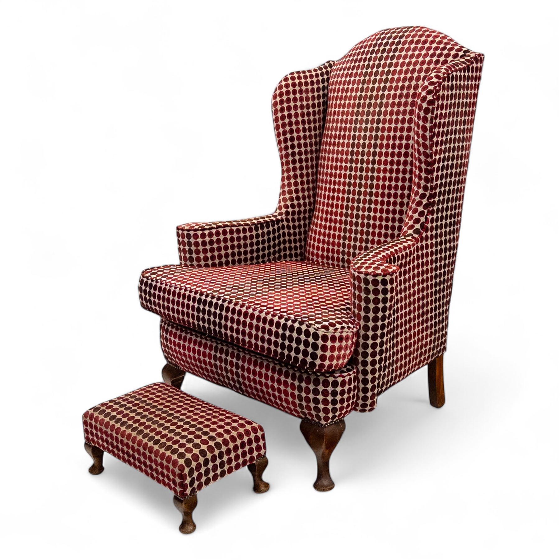 Late 20th century Georgian style wingback armchair with matching footstool, upholstered in red and cream geometric fabric, raised on cabriole front legs