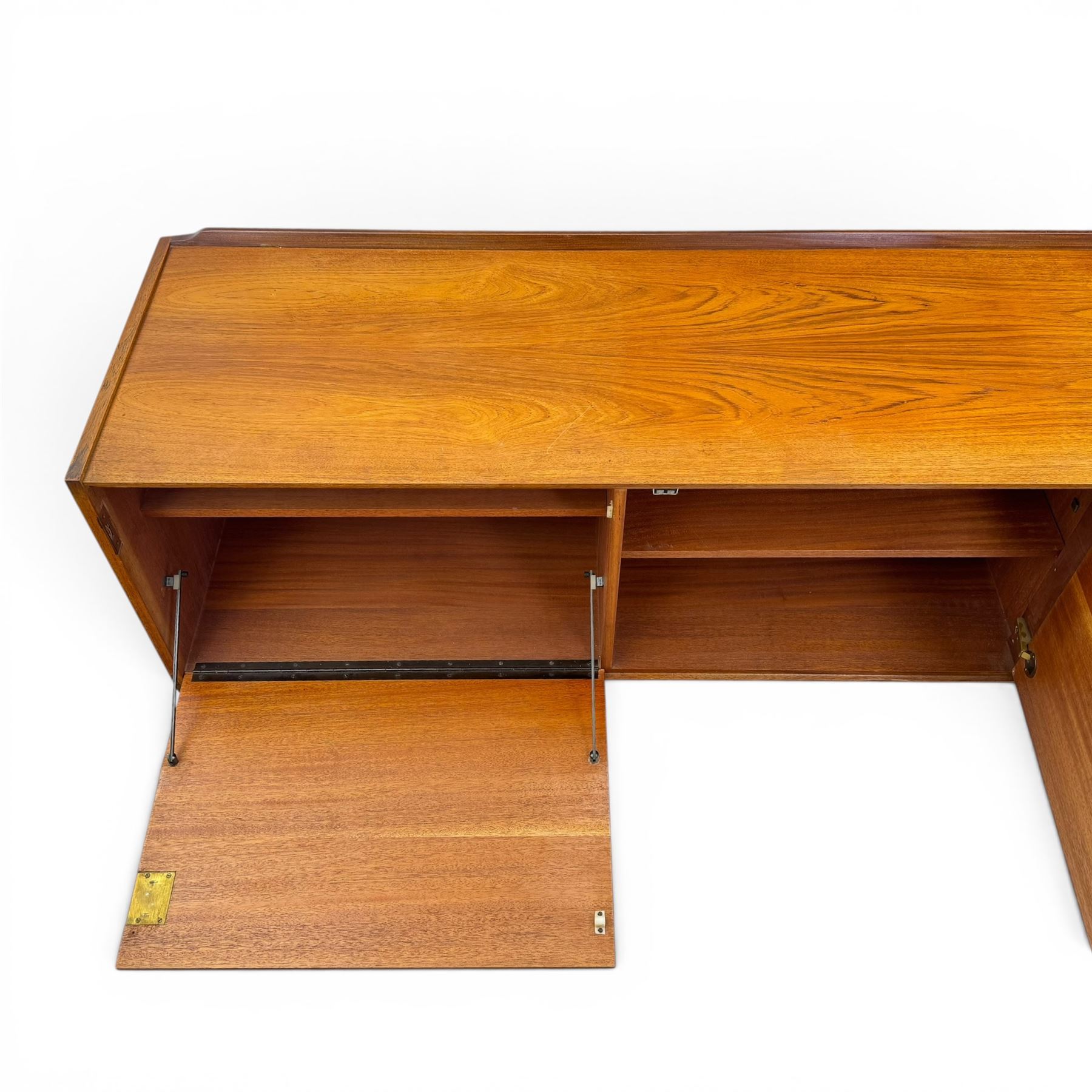 BCM (Bath Cabinet Makers) - mid-20th century teak sideboard, rectangular top with back gallery, left hand side fall front cupboard, centre cupboard opening to reveal a shelved interior, the right side with a bank of three drawers one fitted for cutlery, raised on inset tapering supports