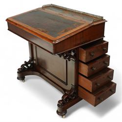 Large Victorian mahogany Davenport, the sloped leather inset writing surface opening to reveal fitted interior, with four drawers to one side and opposing dummy front cupboard door, carved scrolled supports and panelled back, raised on turned feet with brass castors 