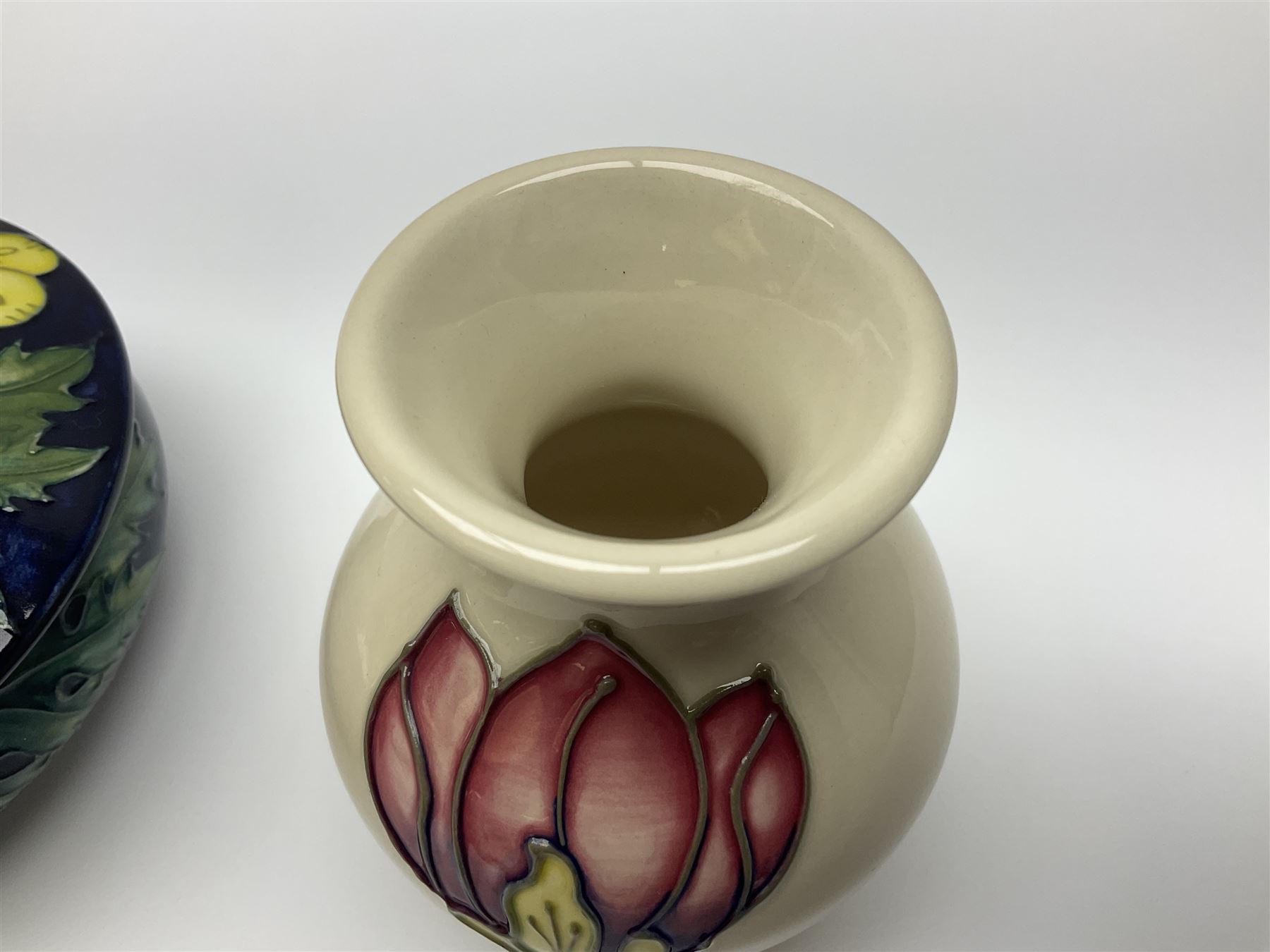 Moorcroft dish and cover, of circular form, decorated in Buttercup pattern, together with a Moorcroft vase, of baluster form, decorated in Magnolia pattern, both with printed marks beneath, tallest H9.5cm