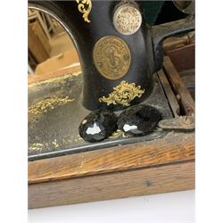Two vintage sewing machines, the first marked Federation, in mahogany case, the second marked Singer, in oak case. 