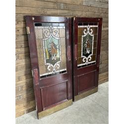 Two early to mid 20th century timber doors, set with lead framed stained glass panels depicting agricultural worker and horse