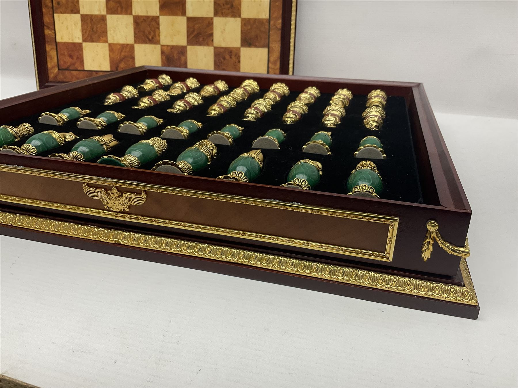 Franklin Mint House of Faberge 'The Imperial Jewelled Chess Set', to include set of chess pieces with malachite finish and a set with carnelian finish and a hardwood chess board