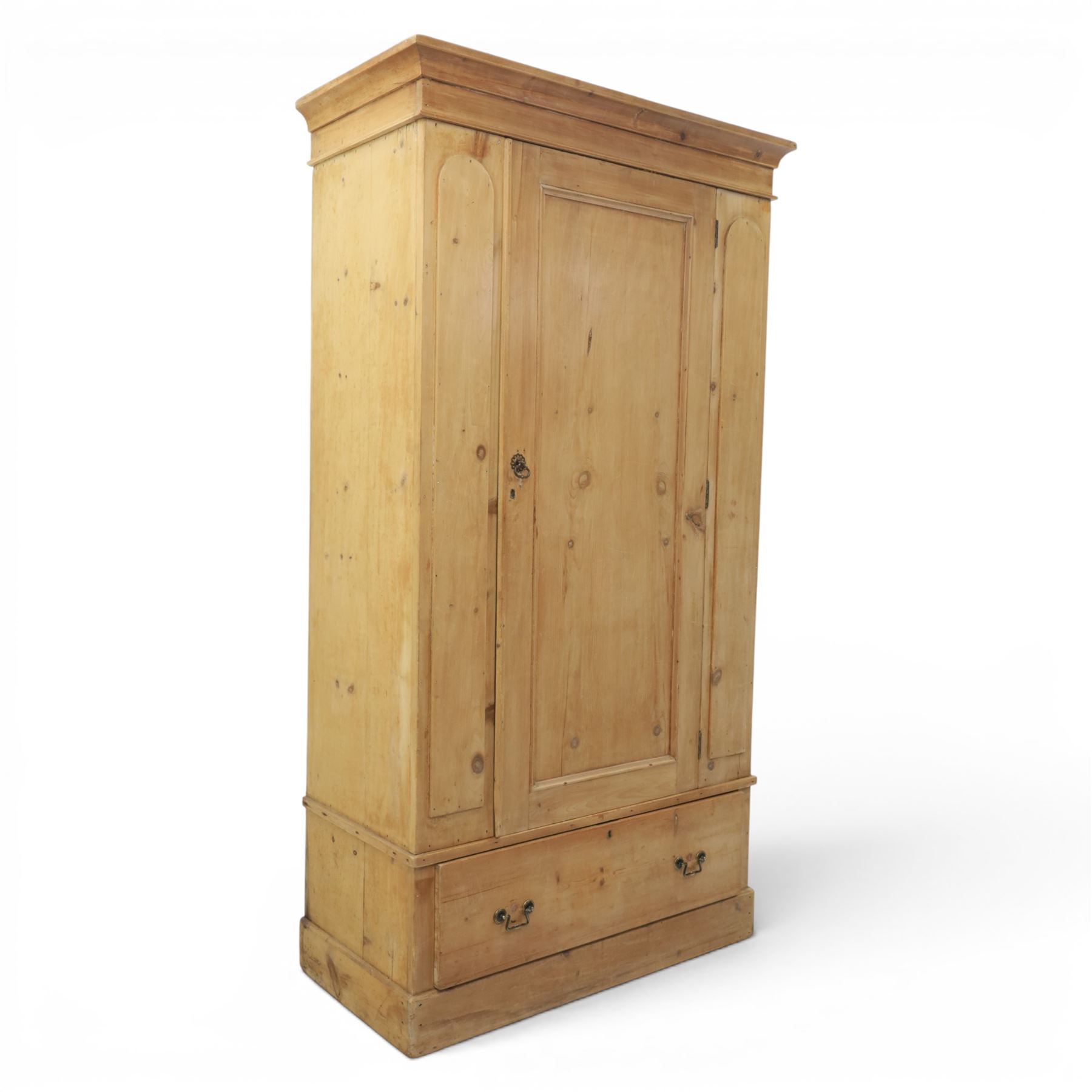 Traditional waxed pine single wardrobe, featuring single panelled door above base drawer, loop handles
