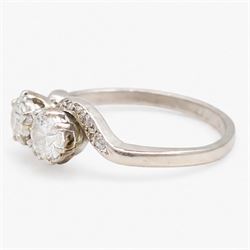 Platinum diamond crossover ring, set with two round brilliant cut diamonds and diamond set shoulders, stamped, total diamond weight approx 0.65 carat