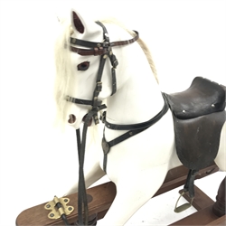 20th century carved and painted wood rocking horse, leather saddle and reins, stirrups, trestle base, L156cm, H121cm
