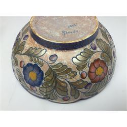Charlotte Rhead for Crown Ducal ceramics, comprising coffin shaped vase depicting a woman in 1920s dress, a vase with handle, decorated with autumn leaves and a bowl, decorated with flowers and berries, with printed and signed marks beneath, coffin vase H24cm