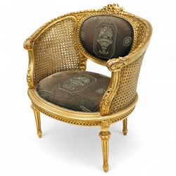 Louis XVI design tub armchair, studded upholstered padded back and seat with double cane side panels on fluted legs 