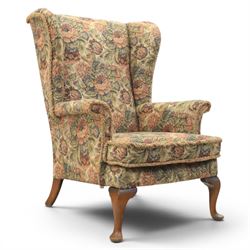 Parker Knoll - pair of mid-20th century wing back armchairs, upholstered in tapestry fabric, raised on cabriole legs