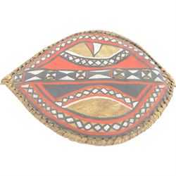 Maasai shield, made of hide, with white, red and black pigment decoration, the back attached to a wooden frame with hide stitching, together with two Maasai spears, shield H70cm, spears L120cm