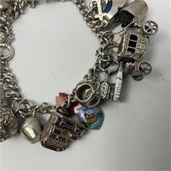Silver charm bracelet, with twenty eight charms, including typewriter, rocking chair, carriage, cauldron, etc