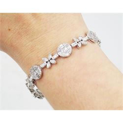 18ct white gold diamond bracelet, eight circular, pave set round brilliant cut and baguette cut diamond clusters, spaced by a single baguette cut diamond and a diamond flower head design cluster, stamped 750, total diamond weight approx 3.70 carat
