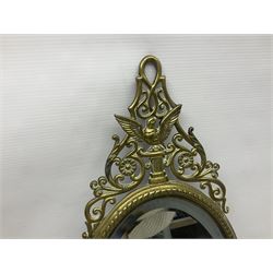 Brass oval girandole wall mirror, with openwork pediment above a bevelled mirror plate