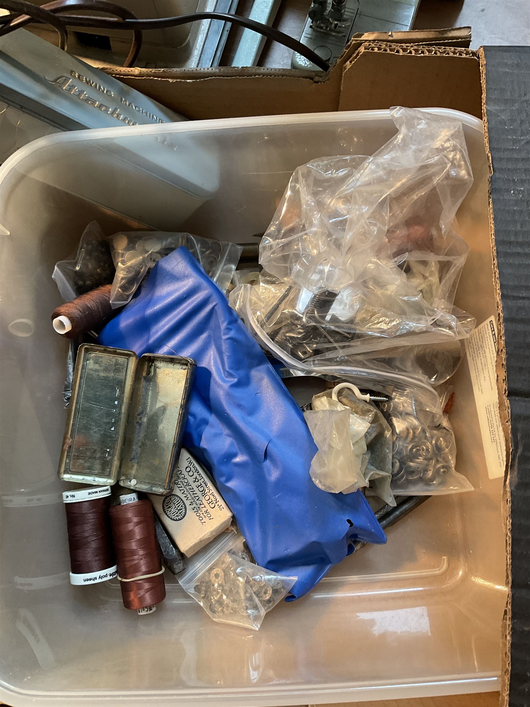 Two Singer sewing machines, model numbers 527 and 457, together with various Singer sewing machine parts, and a selection of sewing related accessories, to include threads, sewing needles, etc.