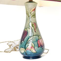 Moorcroft Fuchsia pattern table lamp, impressed marks to base, excluding fittings H32cm; together with a Bermuda Lily pattern vase, impressed marks and signed to base, H19cm (2)