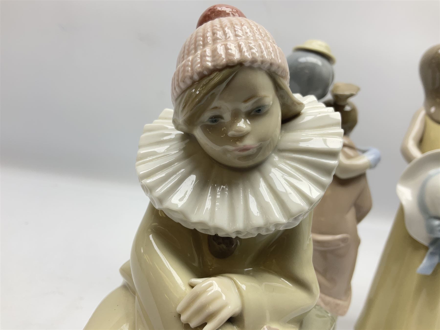 Three Lladro figures, comprising Little Jester no 5203, Pals Forever no 7686 and Naughty Girl no 5006, H25cm
