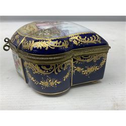 Sevres style late 19th/early 20th century trinket box decorated in the rococo style, the shaped cover painted with an 18th century courting couple in a garden scene opening to reveal the interior painted with floral sprays, the conforming body with a painted panel of floral decoration, all reserved upon cobalt blue ground with foliate gilt borders, with interlaced L's mark beneath, L12cm H6cm