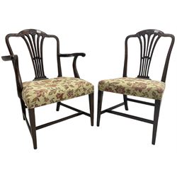 George III Hepplewhite design mahogany elbow chair and matching side chair, cresting rail carved with bellflowers over pierced and flared splat, seats upholstered in floral patterned fabric, raised on square tapering supports united by stretchers