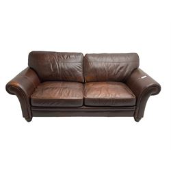Traditional shaped large two seat sofa with scrolled arms, upholstered in chocolate brown leather with olive green back, raised on turned feet