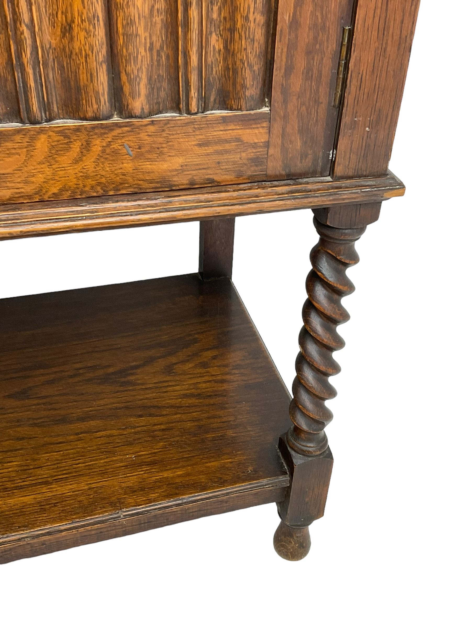 Early to mid-20th century oak dresser, raised two tier plate tack over two linenfold panelled doors, on spiral turned supports united by undertier 