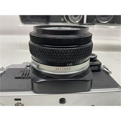 Four Olympus camera bodies, including Olympus OM10, serial no 20744269, with 'Olympus OM-System Zuiko Auto-S 50mm 1:1.8' lens serial no 3633644, Olympus OM-2 camera body serial no 460280 with 'Olympus OM-System G.Zuiko Auto-s 1:1.4 f=50mm' lens, serial no 729750, etc 