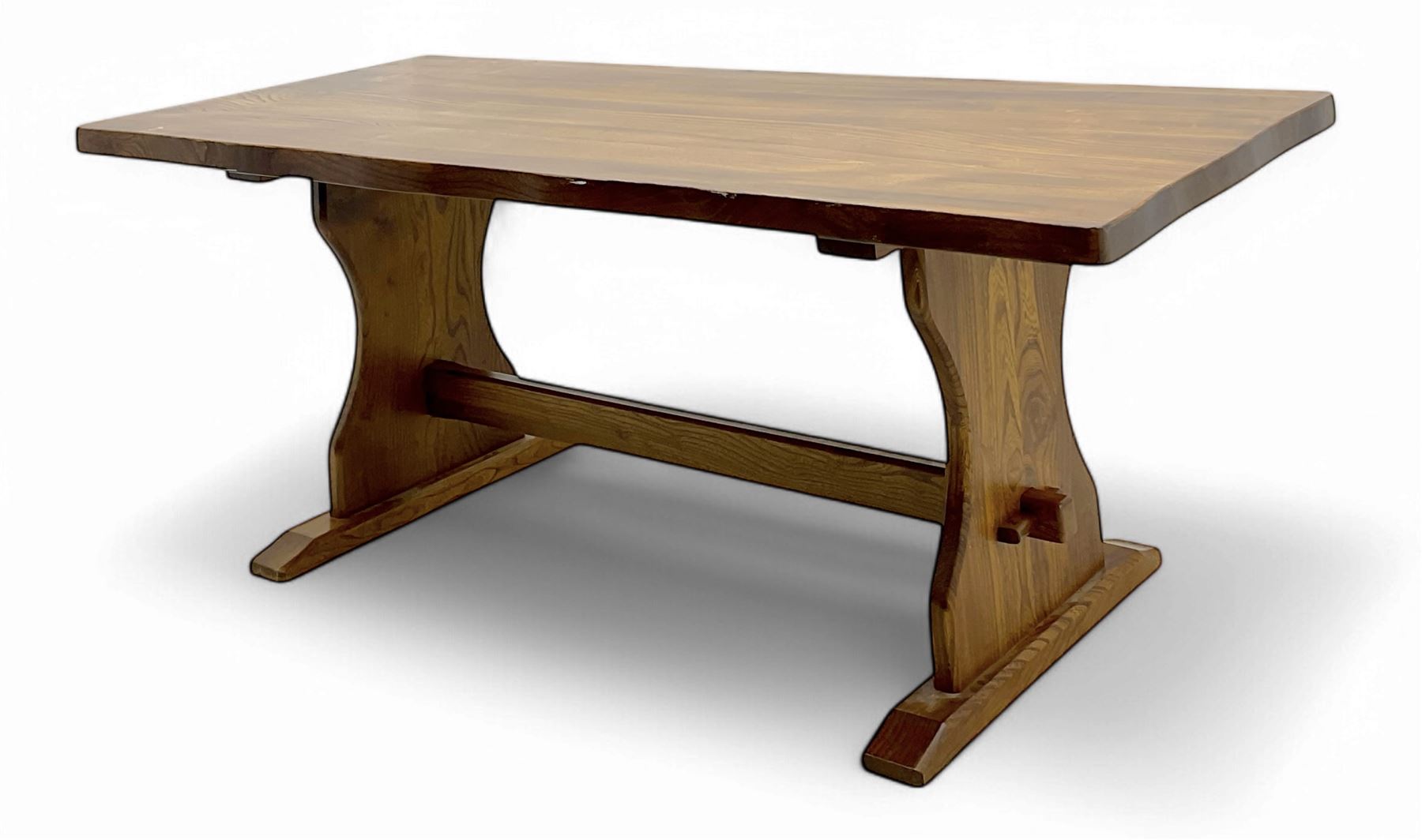 Late 20th century oak trestle table, rectangular top with naturalistic edge, supported by two curved pedestal bases united by central stretcher, on block feet