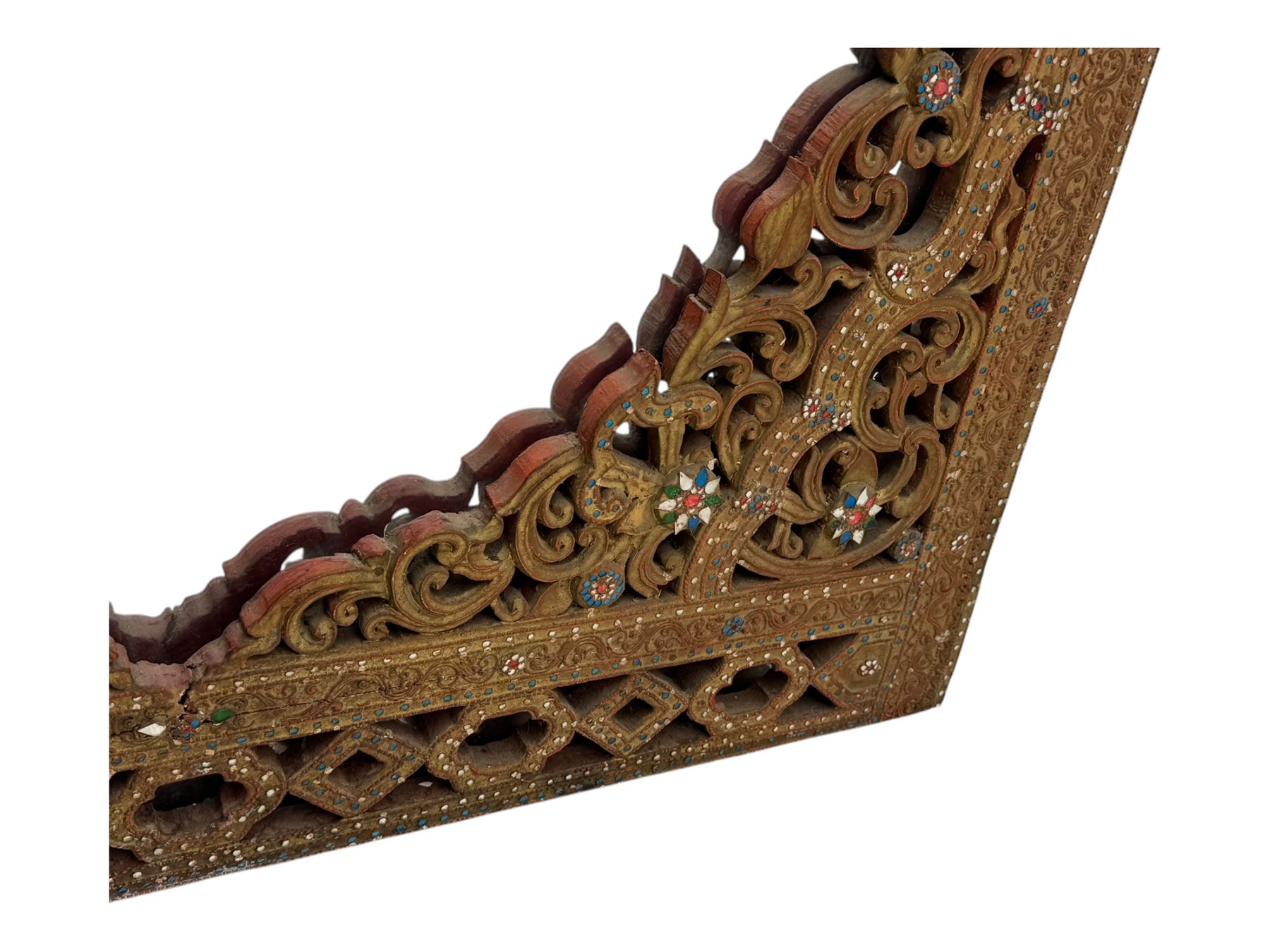 Large North African design carved and painted wall mirror, decorated with floral motifs, pierced foliate scrolls, inset mirrored panels, and colourful painted detailing, enclosing an oval bevelled mirror plate