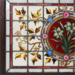 Victorian Aesthetic movement stained glass leadlight window panel, the central panel hand painted with a sprig of daffodils, the surrounding panels profusely decorated with branches and leaves, overall 62cm x 84cm 