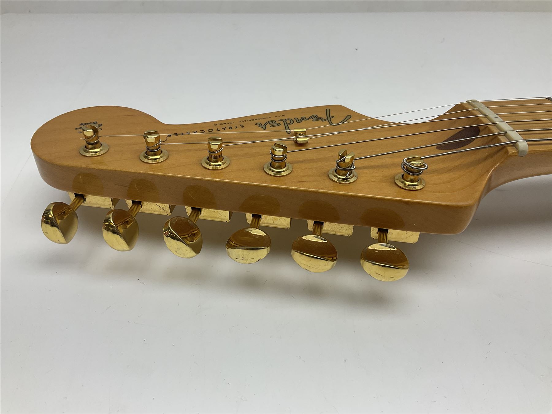 Fender Stratocaster 50th Anniversary 2004 metallic gold electric guitar; serial no.MZ4116369; L98cm; in Spider fitted case with owners manual and other paperwork, strap and belt buckle etc