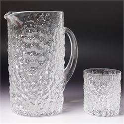 Four Whitefriars glass examples, comprising Ruby Red Wave ribbed vase, designed by Marriott Powell, a Glacier jug and whisky tumbler designed by Geoffrey Baxter, and a conical doorstop, with controlled bubbles around an orange centre, jug H19cm (4)