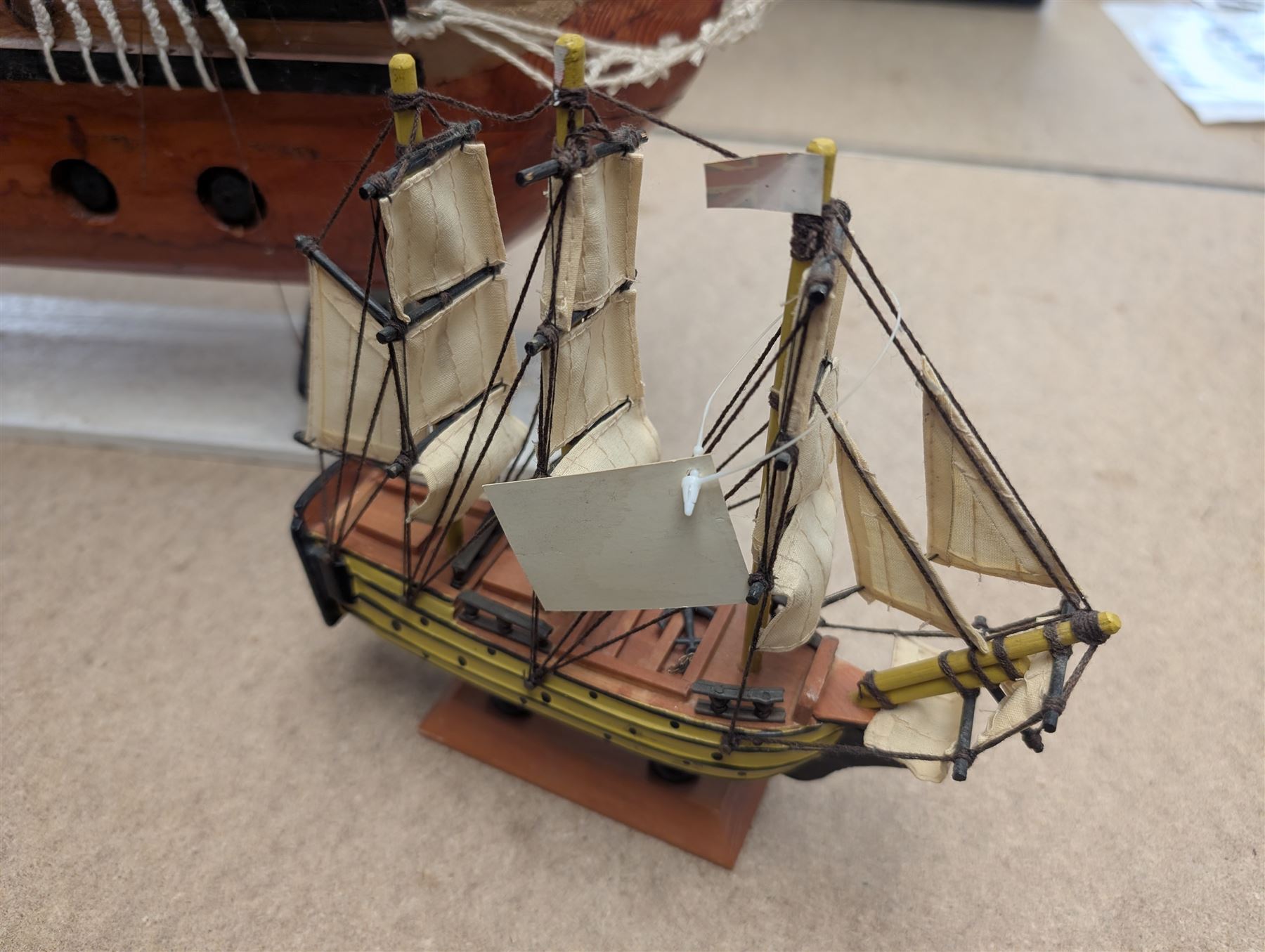 Wooden model ship 'Mayflower', together with a similar smaller example, largest H56cm