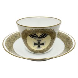 WW2 Nymphenburg cups and saucer, decorated with Imperial German Iron Cross encircled in a foliate boarder with gilt edging, with printed mark beneath 