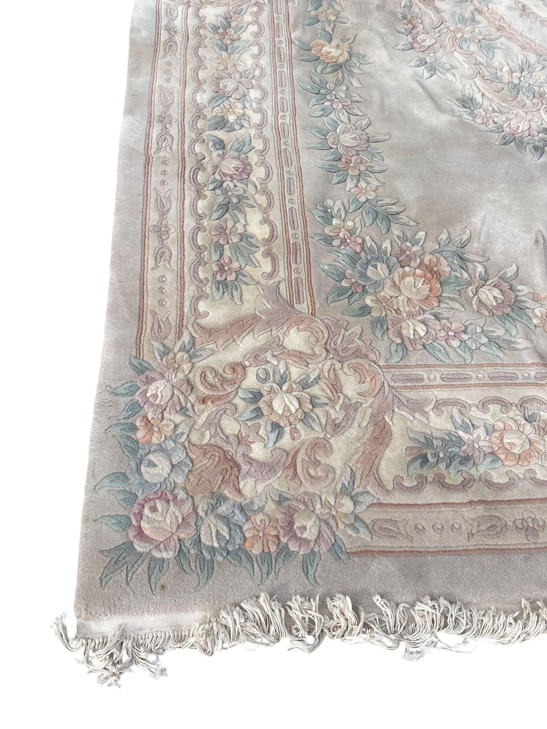 Chinese washed woollen pale ground carpet with overall floral design 
