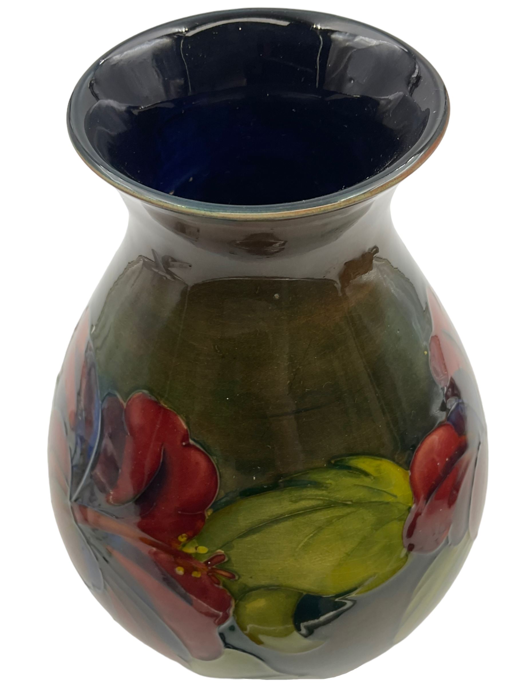Moorcroft vase of bulaster form, decorated in Hibiscus pattern upon a green ground, H21cm 
