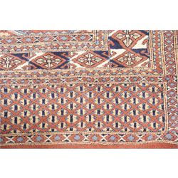Afghan Turkoman crimson ground rug decorated with twin rows of hooked geometric guls within broad compartmented geometric borders (125cm x 201cm); Afghan Bokhara rug with repeated octagonal guls on a terracotta ground, enclosed by multiple geometric borders and patterned elem panels (120cm x 192cm) (2)