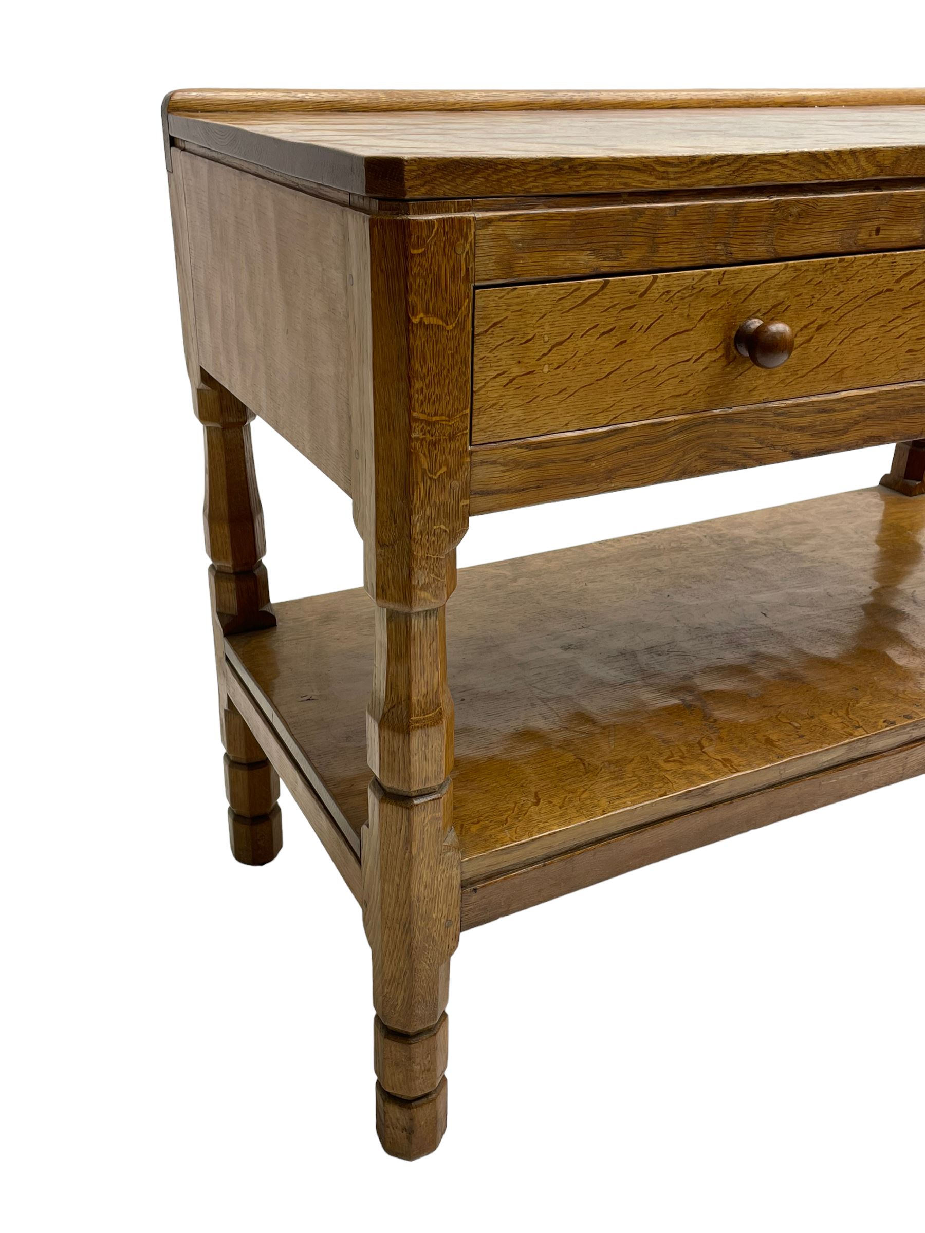 Mouseman - circa. 1950s oak serving table, adzed rectangular top over two drawers, on octagonal supports joined by adzed undertier, the rear right leg carved with mouse signature, by Robert Thompson of Kilburn